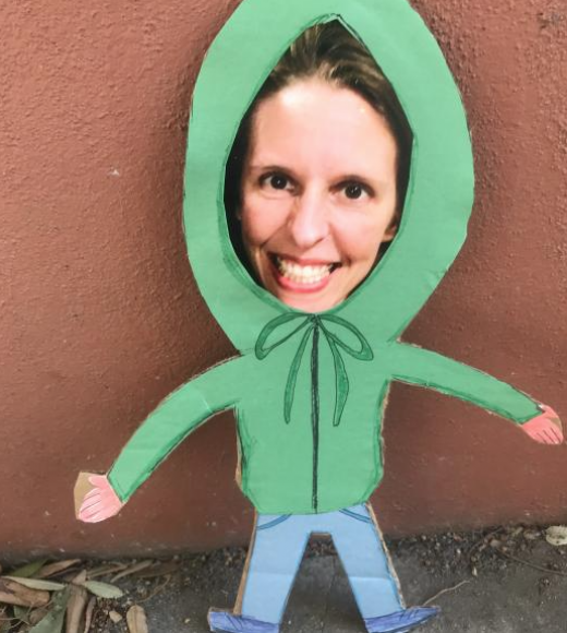 a photo of courtney's smiling face is cutout and placed on a small figure with a green hoodie and jeans