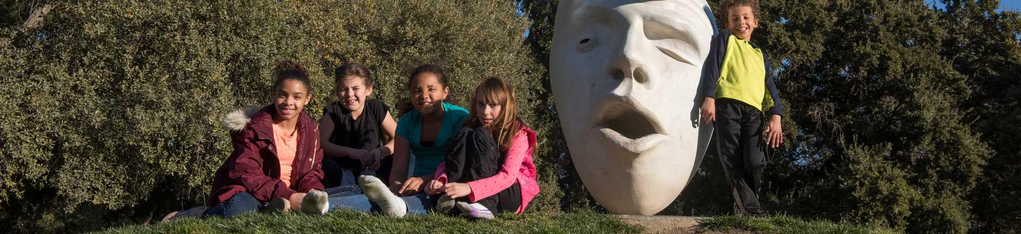 children posing with campus egghead